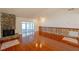 Bright living room featuring a stone fireplace and sliding glass doors leading to a sunroom at 2311 Wekiva Ridge Rd, Apopka, FL 32712