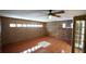 Living area showcasing brick and wood-paneled walls and a tile floor at 2311 Wekiva Ridge Rd, Apopka, FL 32712