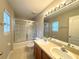 Clean bathroom with double vanity and a tub shower combo at 2878 Grasmere View Pkwy, Kissimmee, FL 34746