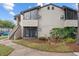 Tan condo building exterior with stairs and small patio at 2924 Antique Oaks Cir # 46, Winter Park, FL 32792