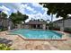 Community pool with stone patio and surrounding landscaping at 2924 Antique Oaks Cir # 46, Winter Park, FL 32792