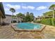 Community pool with stone patio and surrounding landscaping at 2924 Antique Oaks Cir # 46, Winter Park, FL 32792