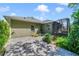 Exterior backyard view featuring brick patio, greenery, and screened-in lanai at 2961 Cedar Glen Pl, Oviedo, FL 32765