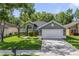 Charming single-story home with a well-maintained lawn and mature trees enhancing curb appeal at 2961 Cedar Glen Pl, Oviedo, FL 32765