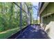 View of the screened lanai with dark carpet flooring, offering a relaxing outdoor space at 2961 Cedar Glen Pl, Oviedo, FL 32765