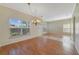 Bright living area featuring wood floors, large windows, and neutral walls, offering a versatile space at 2961 Cedar Glen Pl, Oviedo, FL 32765