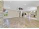 Open-concept living space with tile flooring, a stone fireplace, and a view of the kitchen at 2961 Cedar Glen Pl, Oviedo, FL 32765
