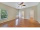 Bright main bedroom featuring laminate flooring, a ceiling fan, and access to the ensuite bathroom at 2961 Cedar Glen Pl, Oviedo, FL 32765