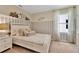 Light and airy bedroom with white bed frame and window at 308 Pelham Park Dr, Deland, FL 32720