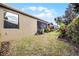 Grass yard with a view of the screened porch at 3649 Corsica Ln, Clermont, FL 34711