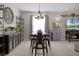 Elegant dining area with a rustic table and modern chandelier at 3649 Corsica Ln, Clermont, FL 34711