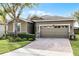 One story house with a two-car garage and landscaped front yard at 3649 Corsica Ln, Clermont, FL 34711