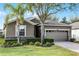 One-story house with a two-car garage and lush landscaping at 3649 Corsica Ln, Clermont, FL 34711