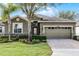One-story house with a two-car garage and manicured lawn at 3649 Corsica Ln, Clermont, FL 34711