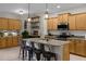 Spacious kitchen with island, wood cabinets, and granite countertops at 3649 Corsica Ln, Clermont, FL 34711