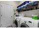 Convenient laundry room with washer, dryer, and shelving at 3649 Corsica Ln, Clermont, FL 34711