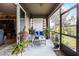 Relaxing screened porch with seating area and lush plants at 3649 Corsica Ln, Clermont, FL 34711