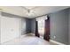 Gray bedroom with ceiling fan and window coverings at 3917 Derby Dr, Lakeland, FL 33809