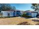 Blue house with a two-car garage and a well-maintained lawn at 3917 Derby Dr, Lakeland, FL 33809