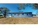 Back of house with sliding glass doors and a small patio at 3917 Derby Dr, Lakeland, FL 33809