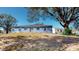 Back of house with sliding glass doors and a yard at 3917 Derby Dr, Lakeland, FL 33809