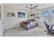 Bright bedroom with a bed, gaming chair, and ceiling fan at 394 Singing Tree Ln, Winter Springs, FL 32708