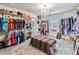 Spacious walk-in closet with custom shelving and rods at 394 Singing Tree Ln, Winter Springs, FL 32708