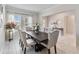 Dining room with dark wood table, neutral chairs, and access to the entryway at 394 Singing Tree Ln, Winter Springs, FL 32708