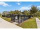 Fenced dog park with shaded seating area at 394 Singing Tree Ln, Winter Springs, FL 32708