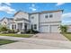Two-story house with white siding, stone accents, and a two-car garage at 394 Singing Tree Ln, Winter Springs, FL 32708