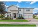 Two-story house with white siding, stone accents, and a two-car garage at 394 Singing Tree Ln, Winter Springs, FL 32708