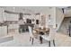 Modern kitchen with white cabinets, an island, and a dining area at 394 Singing Tree Ln, Winter Springs, FL 32708