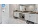 Elegant bathroom with double vanity, large mirror, and marble tile floors at 394 Singing Tree Ln, Winter Springs, FL 32708