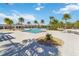 Community pool with lounge chairs and palm trees at 394 Singing Tree Ln, Winter Springs, FL 32708