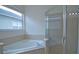 Bathroom with corner bathtub, shower, and window at 4911 Santa Clara Dr, Orlando, FL 32837