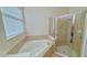 Bathroom boasts a corner tub, shower, and window for natural light at 4911 Santa Clara Dr, Orlando, FL 32837