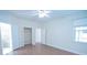 Bright bedroom with wood floors, ceiling fan, and ample closet space at 4911 Santa Clara Dr, Orlando, FL 32837