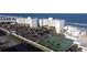 Aerial view of oceanfront community with tennis court and parking at 5203 S Atlantic Ave # 815B, New Smyrna Beach, FL 32169
