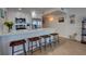 Bright kitchen boasts white cabinets, quartz countertops, and breakfast bar at 5203 S Atlantic Ave # 815B, New Smyrna Beach, FL 32169