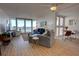 Bright living room with ocean view, comfy seating and hardwood floors at 5203 S Atlantic Ave # 815B, New Smyrna Beach, FL 32169