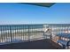 Breathtaking ocean view from balcony, featuring white chairs and railings at 5203 S Atlantic Ave # 815B, New Smyrna Beach, FL 32169
