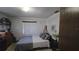 King sized bed and wood floors in bright bedroom at 547 Queens Mirror Cir, Casselberry, FL 32707