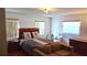 Spacious bedroom with a double bed, couch, and wood floors at 547 Queens Mirror Cir, Casselberry, FL 32707