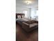 Bright bedroom with double bed, couch and wood floors at 547 Queens Mirror Cir, Casselberry, FL 32707