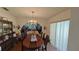Formal dining room with a large table and chandelier at 547 Queens Mirror Cir, Casselberry, FL 32707