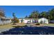 Single-story home with driveway, landscaping, and fenced yard at 547 Queens Mirror Cir, Casselberry, FL 32707