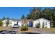 White single story home with a circular driveway and cacti at 547 Queens Mirror Cir, Casselberry, FL 32707