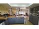 Open concept kitchen with island and gray cabinets at 547 Queens Mirror Cir, Casselberry, FL 32707