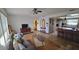 Living room with hardwood floors and view of kitchen at 547 Queens Mirror Cir, Casselberry, FL 32707