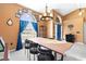 Bright dining room featuring a large wooden table and blue curtains at 645 Dolcetto Dr, Davenport, FL 33897